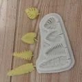 Detailed view of leaf-shaped silicone mold with finished fondant leaves on wood surface - 4-Cavity Maple