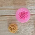 Macro detail view of a rose-shaped silicone mold with a finished fondant flower piece - Rose / Medium Flower / Pink