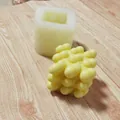 Detailed view of a 3D heart-shaped cube silicone mold and its finished yellow wax candle. - Large Heart Pendant