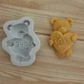 Detailed view of a teddy bear heart silicone mold and its brown finished chocolate cast. - Heart Hugging Bear