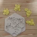 Close-up of flying cartoon bee silicone mold with finished fondant bee figures - Flying Bee