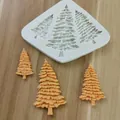 Close-up of a 3-hole Christmas tree silicone mold with orange fondant tree samples - Triple Christmas Tree Style