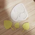 Close-up of pleated palm leaf textures in white silicone mold for cake toppers - 3-Linked Leaf Large / White