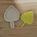 Detail view of palm leaf silicone mold with a finished yellow leaf model on wood - Single Leaf Medium / White