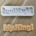 Detailed macro view of white silicone mold and finished My King fondant cake topper decoration - My King