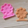 Nahaufnahme von rosa und braunen Riesenrad-Silikonformen für Fondant und Schokolade - Riesenrad-Design / Rosa