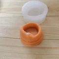 Macro view of coiled snake silicone mold with detailed scale texture on orange product - Snake Shape Candlestick