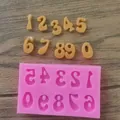 Close-up view of pink silicone number mold with fondant numerical shapes for cakes - Numbers / Pink