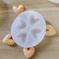 A macro view of a 4-cavity heart silicone mold with finished orange clay hearts. - 4-Cavity Heart with Small Hearts
