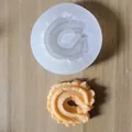 Detail view of a spiral cookie silicone mold and finished fondant shape - 4# (Small Single Hole Spiral)