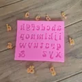 Detailed view of pink silicone alphabet mold with scattered fondant letters - Lowercase Letters / Pink