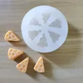 Detailed view of white silicone mold with realistic yellow cheese-shaped finished pieces - Cheese