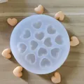 Silicone heart mold showing detailed cavities and finished heart-shaped crafts. - 12-Cavity Heart