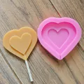Heart-shaped silicone lollipop mold displayed with a finished beige heart candy on wood - Heart Medium