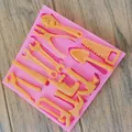 Detailed view of pink silicone mold with various hardware tool shapes for cake decorating - Hardware Tools Shape (Single Piece)