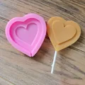 Detail view of heart-shaped silicone mold and finished lollipop on wooden surface. - Large Heart