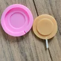 Detailed top-down view of a pink round lollipop silicone mold with a finished sample - Large Circle