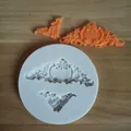 Detail view of European relief silicone mold with orange fondant decoration bits - Style 5 (Round Scroll Floral)