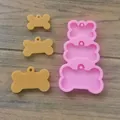 Detail of 3-cavity dog bone silicone mold with resin casting samples on wood surface - 3-Cavity Dog Bone