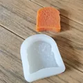 Close-up of a toast-shaped silicone mold with a finished orange bread soap sample - Toast Bread Shape / White