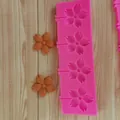 Detail view of pink cherry blossom lollipop silicone mold with finished flower samples - Large Sunflower