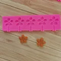 Macro detail of pink sakura flower silicone mold with finished floral chocolates. - Medium Sunflower