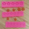 Close-up detail of pink flower lollipop silicone molds featuring orange finished products - Large Daisy
