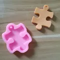 Detailed macro view of a pink puzzle piece silicone mold for DIY resin keychains and soap making - Puzzle Shape (627292185741) / Pink