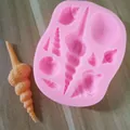 Primo piano di uno stampo in silicone a conchiglia rosa con un pezzo di resina arancione - Conchiglia