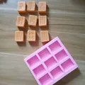 Mahjong tile silicone mold detail with molded orange chocolate pieces on wooden surface - Note