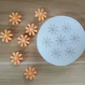 Detail of white silicone daisy flower mold with finished orange fondant samples on wood - Chrysanthemum Style 1 (7 Cavities) / 6.9cmx1.1cm