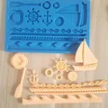 Detail showing various nautical shapes like anchor and sailboat in a blue silicone mold - 5#