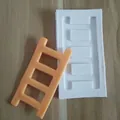Detailed view of white silicone ladder mold and an orange fondant finished product - Large