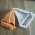 Detail view of a sailboat silicone mold with an orange fondant sailboat model. - Sailboat (3#) / 3#