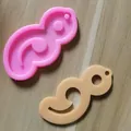 Detailansicht der rosa Silikonform mit ihrer fertigen cremefarbenen Harzform-Probe - Semikolon Form