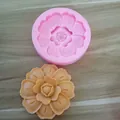 Detail view of a lotus flower silicone mold with finished amber wax candle product - No. 6 (Layered Floral Style)