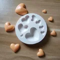 Detailed view of white circular silicone mold with various heart-shaped cavities - Heart