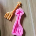 Detailed macro view of pink giraffe silicone mold with orange giraffe fondant sample - Small Giraffe