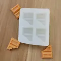 Detail shot of white silicone chocolate mold with bitten bar design and orange wax melts - Chocolate Shape / Half-bitten Chocolate Bar Shape