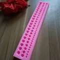 Close-up view of pink silicone mold for creating three sizes of fondant pearl cake decorations. - Large Medium Small 3 Row Pearl String (1124) / Pink