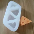 Detailed view of triangular cheese slice silicone mold and finished orange cheese. - 3 Pieces
