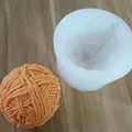 Detailed view of 3D wool ball silicone mold with finished orange textured sphere - Yarn Ball Shape / White