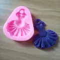 Detailed view of pink dress-shaped silicone mold with its purple fondant outcome - Pink Dress Style (Item No. Dress)
