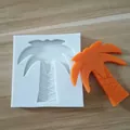 Silicone baking mold in coconut tree shape shown with an orange finished decoration piece - Palm Tree
