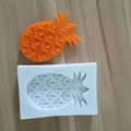 Macro view of pineapple shaped silicone baking mold with finished product detail. - Pineapple