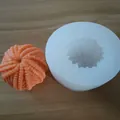 Detailed view of 3D knitting yarn ball silicone mold with finished orange wax sample - Yarn Ball Style (Wool Ball)