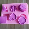 Detail van een roze siliconen mal met zes vormen en paarse boetseerklei voorbeelden. - 6-Holte Multi-Vorm Wafelvorm (Roze)