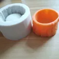 Detail showing white silicone mold and finished orange tree stump planter pot - Tree Trunk Shape