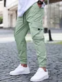 Detailed view of light green cargo joggers featuring a drawstring waist and side pockets - Light Green