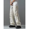 Men's off-white high street cargo pants featuring black side stripes and relaxed fit design - S / Bottoms / Off White